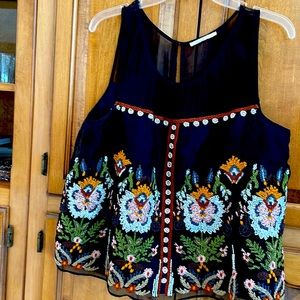 Black embroidered sleeveless tank. In sheer and silk. Lining attached. Size L